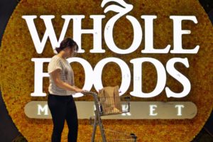 Whole Foods Market store logo with shopper for web Amazon to acquire Whole Foods Market