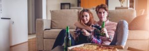 couple watching TV Consumer spending up 2.2% in February - but storms hamper retail sector